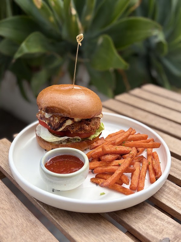 Burger and fries on an outdoor table